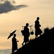 Tibet local walking up a slope after sunset